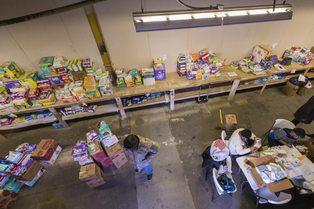 Volunteers at the Western Pennsylvania Diaper Bank pack donations for distribution to sites across Allegheny County. The organization estimates the county's "diaper gap" to be as high as 77,000 per day. 